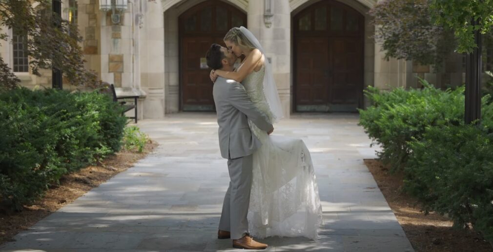 a happy couple kissing at their wedding outside
