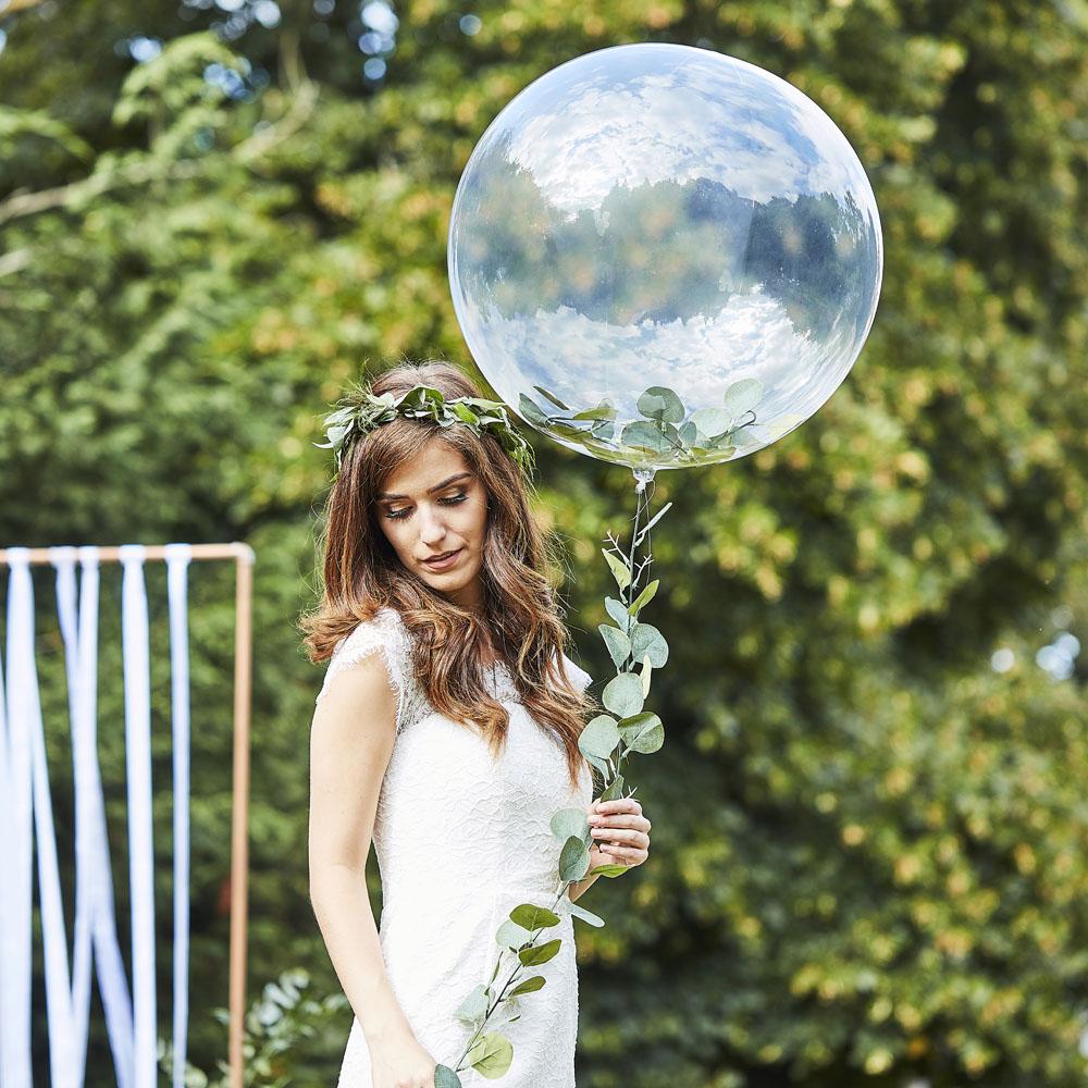 bride in a wreath holding a balloon in the shape of a flower
