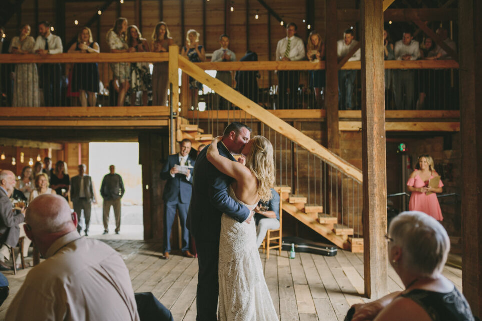 A bride and groom kiss during a wedding ceremony at a farm in Walla Walla