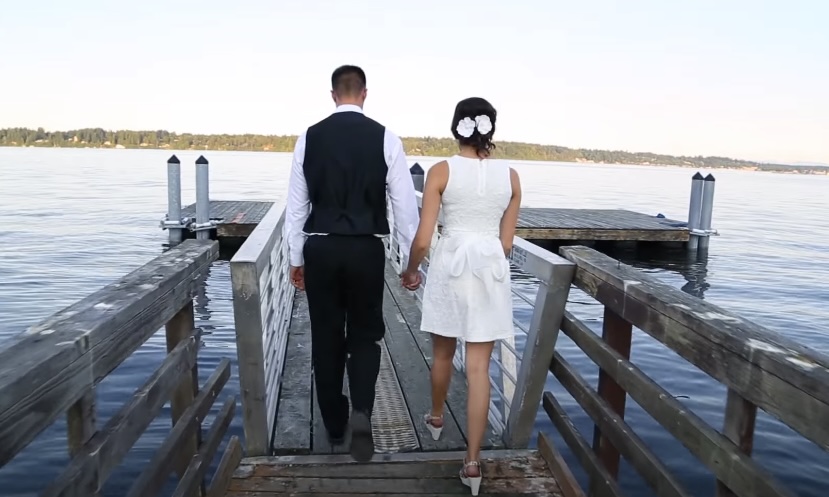 Bride and groom walking on a boardwalk
