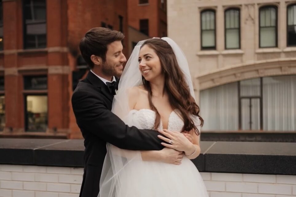 Bride and groom embracing on a rooftop at the Shinola Hotel