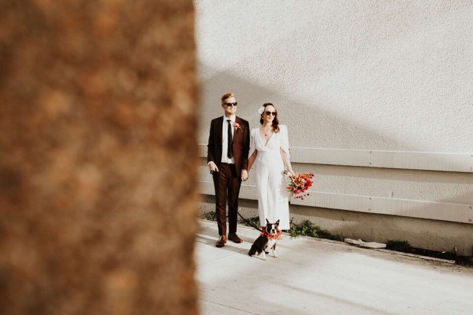 the bride and groom are walking down the promenade