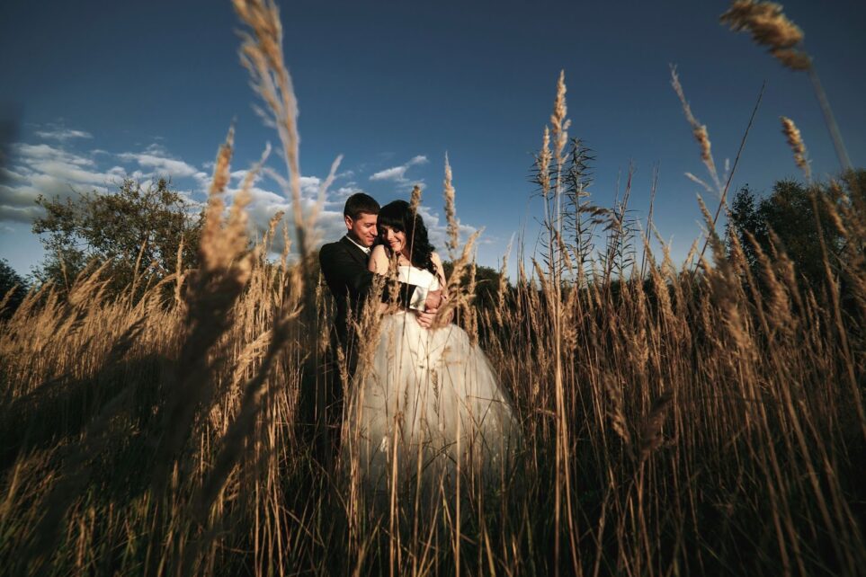 Photo of newlyweds in field