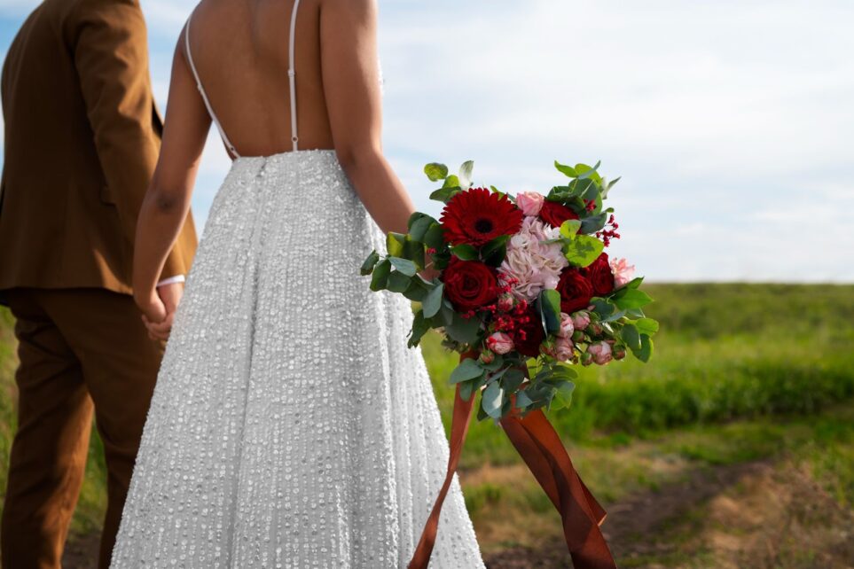 Side view of bride and groom posing outdoors
