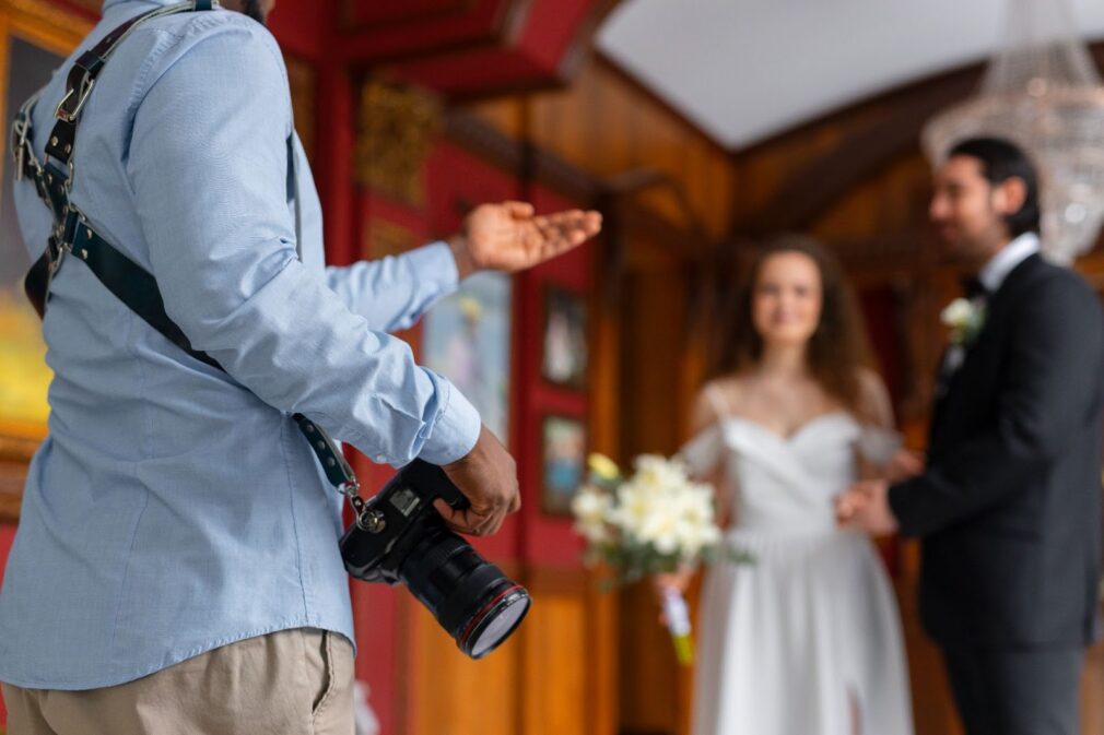 Photographer discuss wedding photos with couple